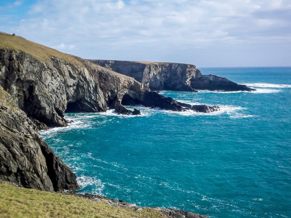 The cliffs meeting the blue water of the Atlantic Ocean at Mizen Head, in County Cork