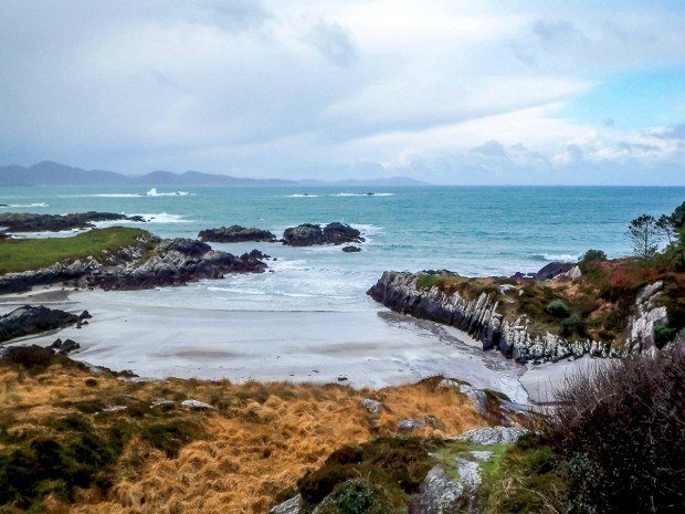 The colorful coastline of Ireland's Ring of Kerry on an overcast day. We explore two of the country's famous drives -- what's better -- Dingle Peninsula or Ring of Kerry?