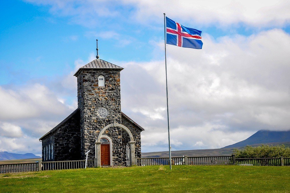 Beautiful stone church and flag on a trip to Iceland in September.