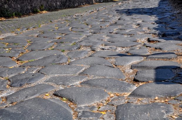 All Roads Lead to Rome on the Appian Way The rough cobblestones of the Appian Way Rome.