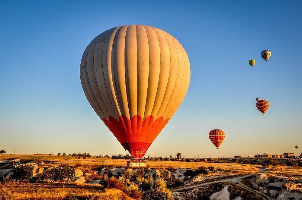 Hot air balloons landing in a field