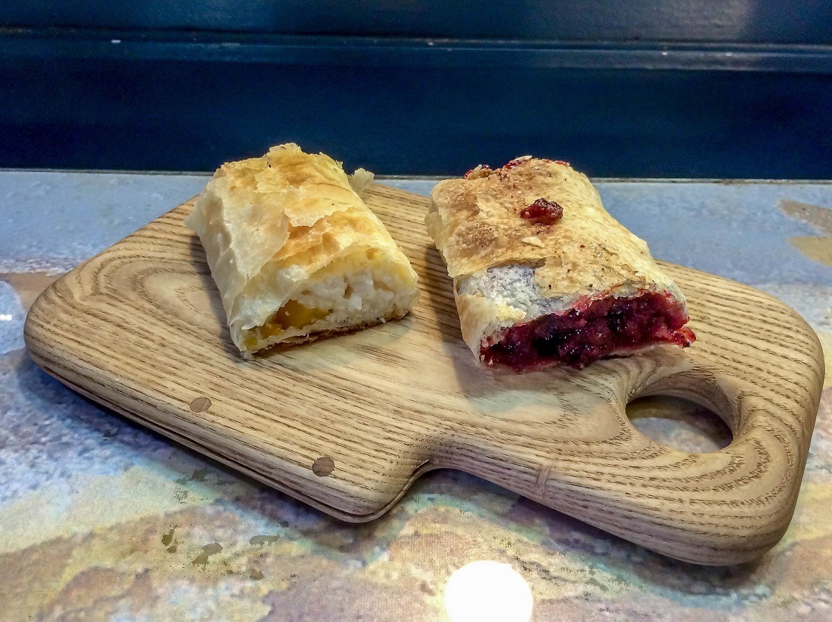 Sampling the cherry strudel and cheese strudel (called retes in Hungary) during our Budapest food tour at the Central Market.