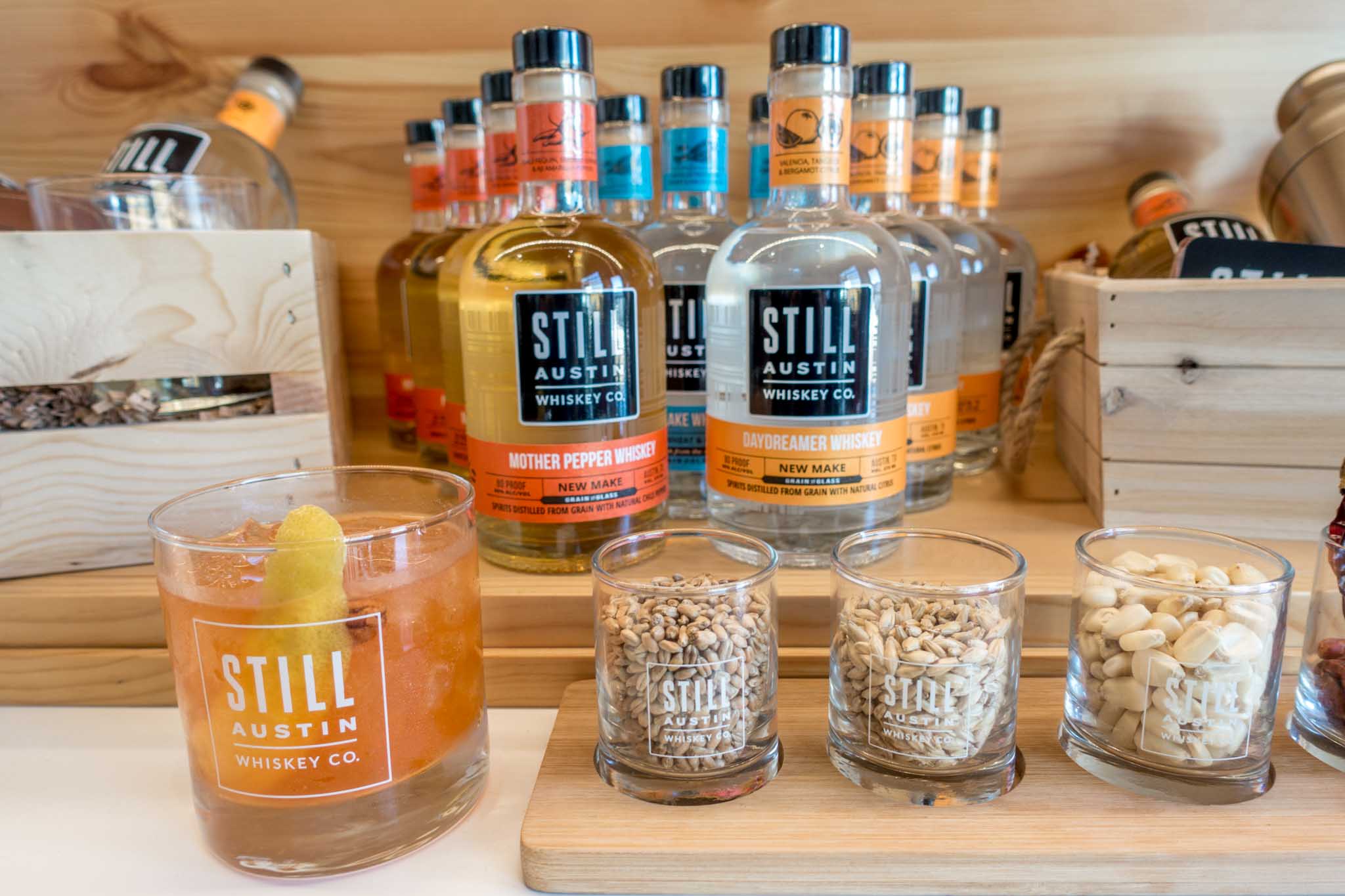 Bottles and cocktail at Still Austin Whiskey Co, one of the a new whiskey distillery in Texas