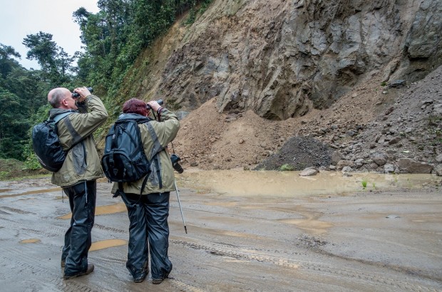 Seven Signs You Are Not a Birder Couple looking for bird on a hill