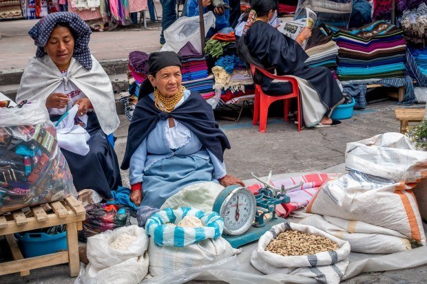Women traditional dress selling beans and lentils in Otavalo's main square, called Plaza de los Ponchos.