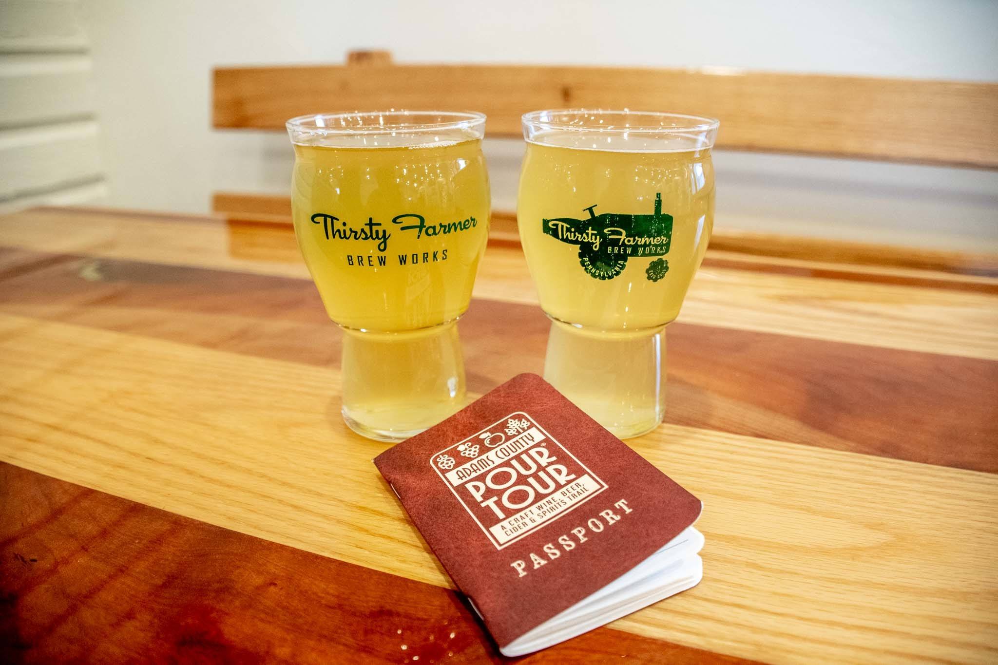 Full beer glasses and a "Pour Tour" booklet on table at the Thirsty Farmer
