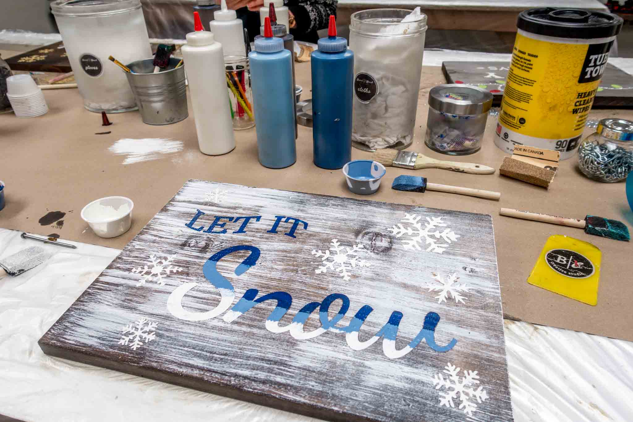 Painting supplies and painted sign at Board and Brush in Gettysburg PA
