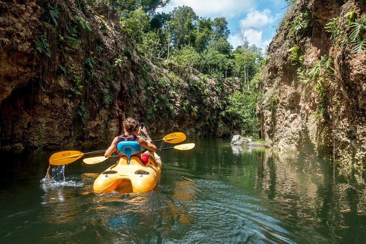 Kayaking through a cenote in Puerto Morelos Mexico. This is just one of four activities on a tour with Xenotes Oasis Maya.