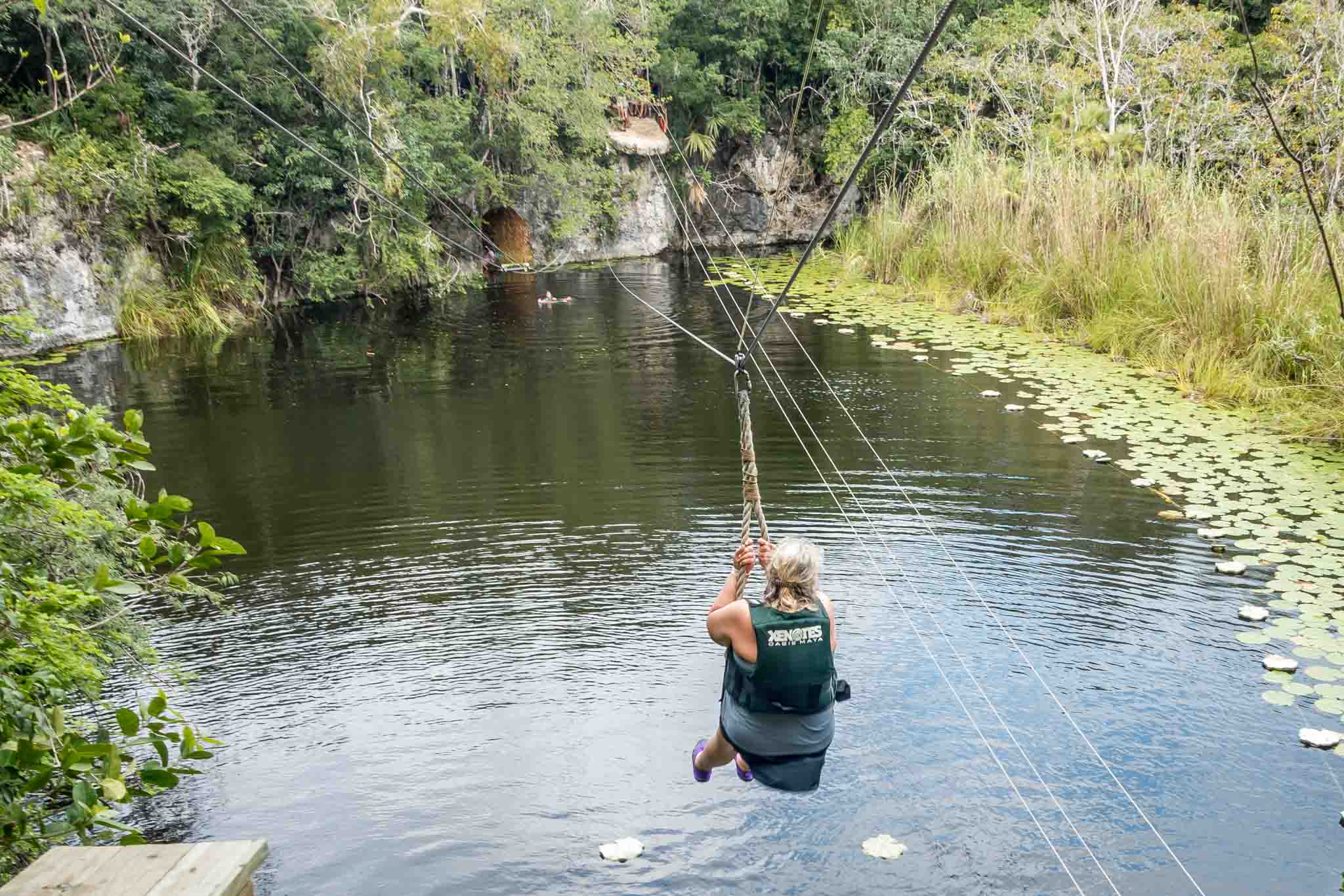 Zip lining into a cenote in Mexico with Xenotes Oasis Maya