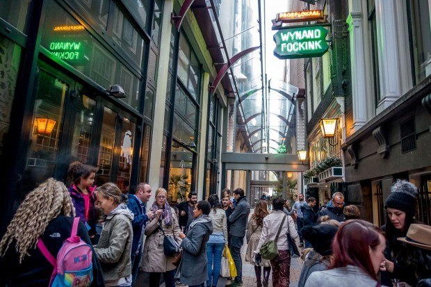 visitors enjoying genevers and liqueurs outside Wynand Fockink, a 300-year-old tasting room in Amsterdam