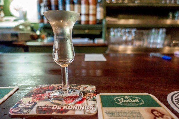 A glass filled to the brim with genever at De Drie Fleschjes, a tasting room in Amsterdam