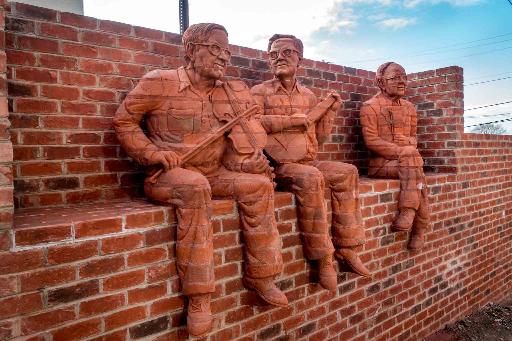 The Whittling Wall features brick sculptures of musicians in downtown Mt Airy North Carolina