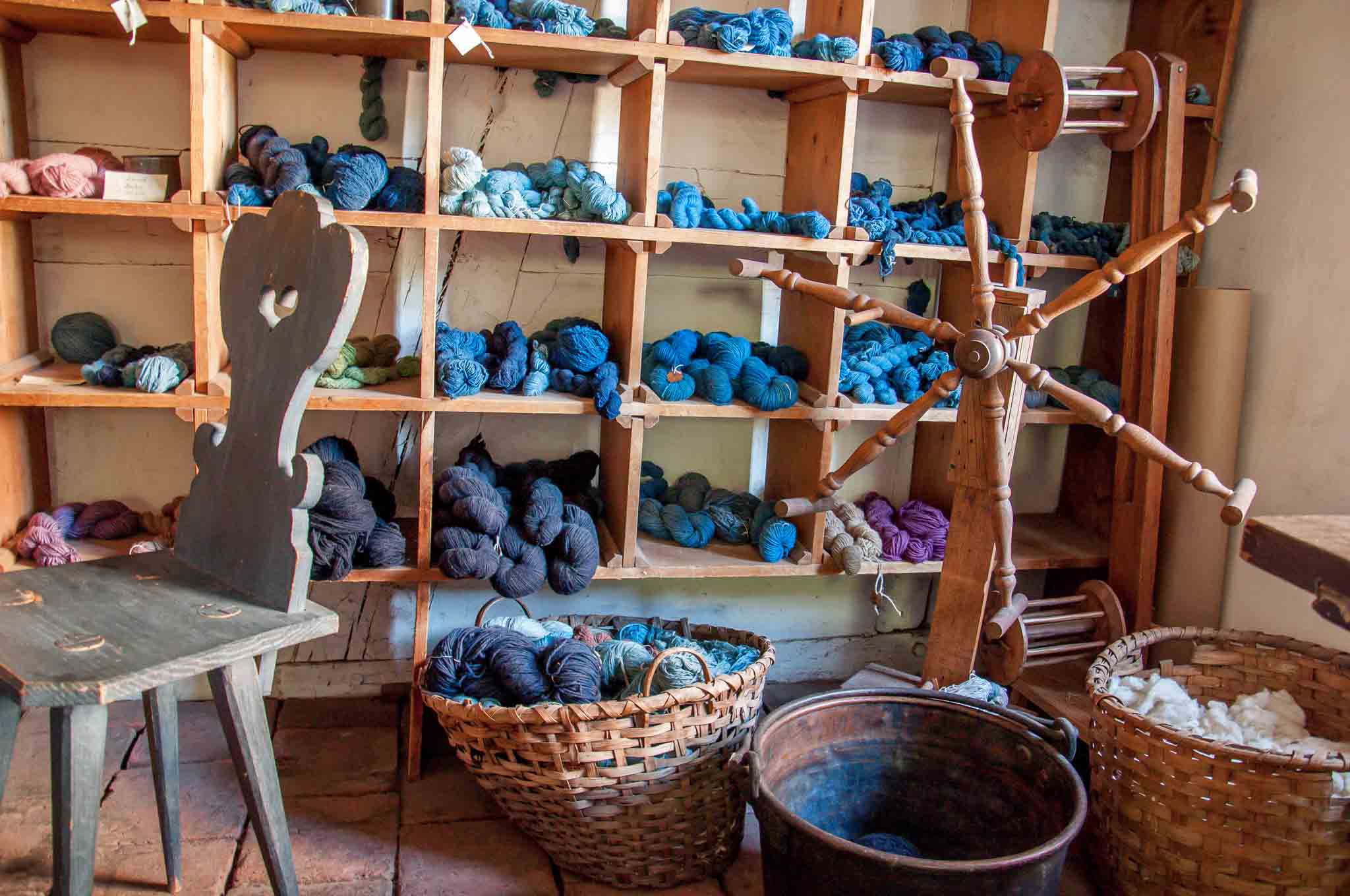 Colorful yarn skeins and spinning wheel