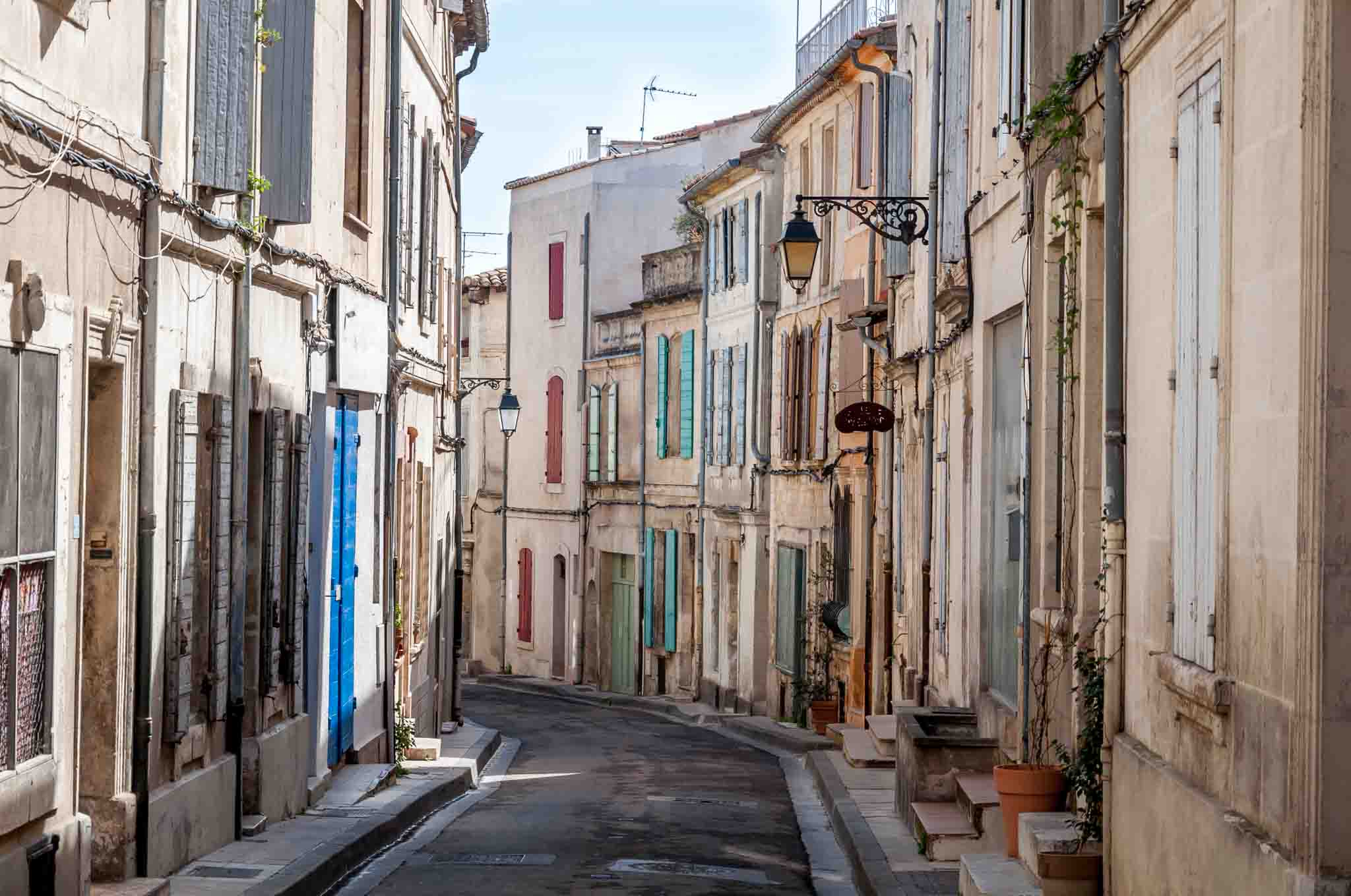 Homes with colorful shutters on a street in Arles, France