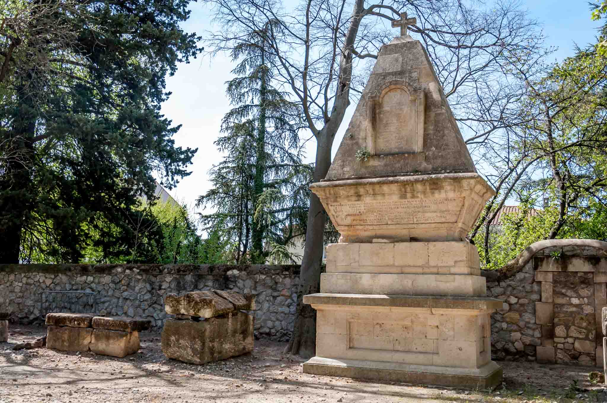 Large stone sarcophagus topped with a cross