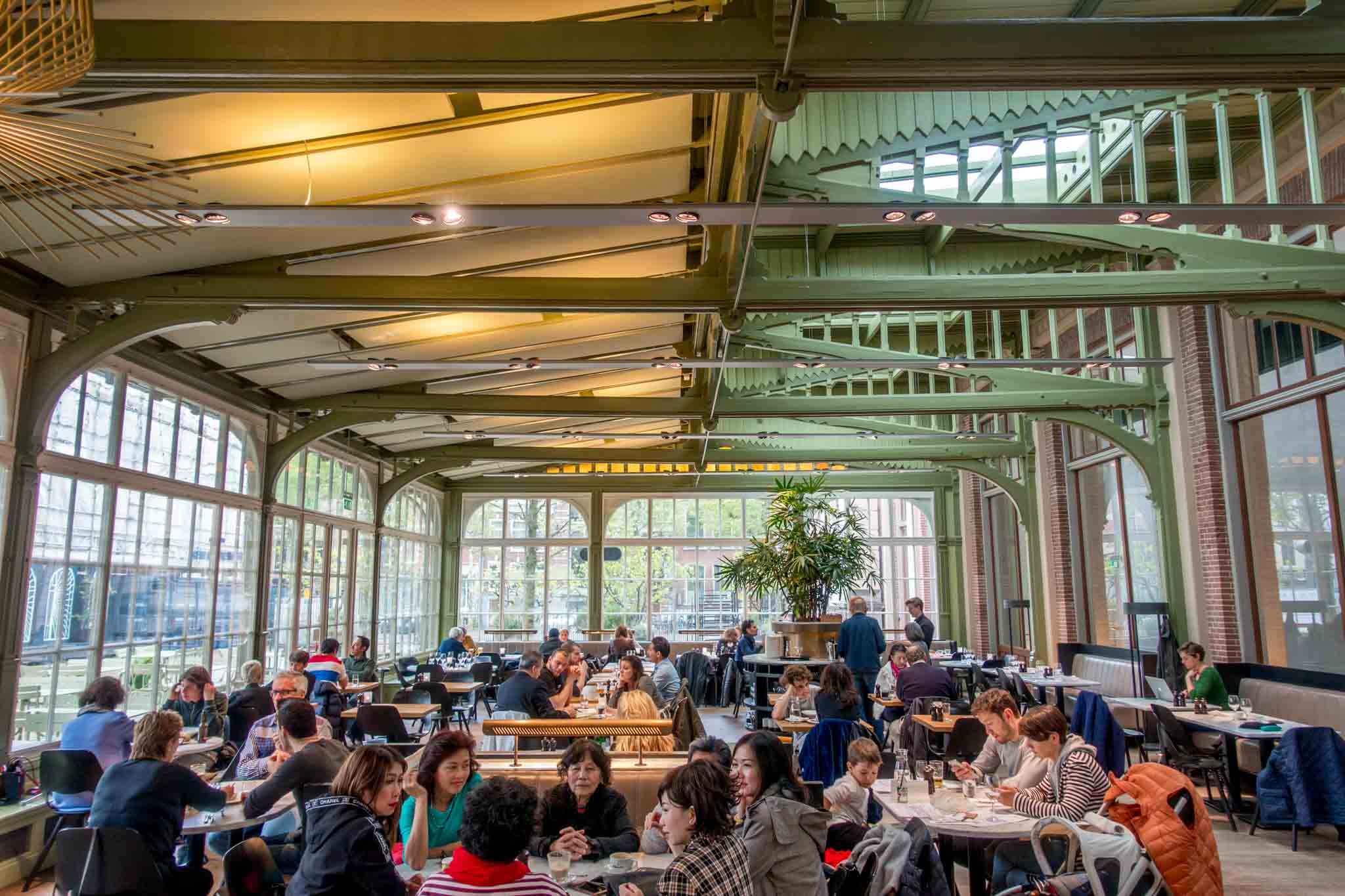 People eating at a restaurant with glass walls