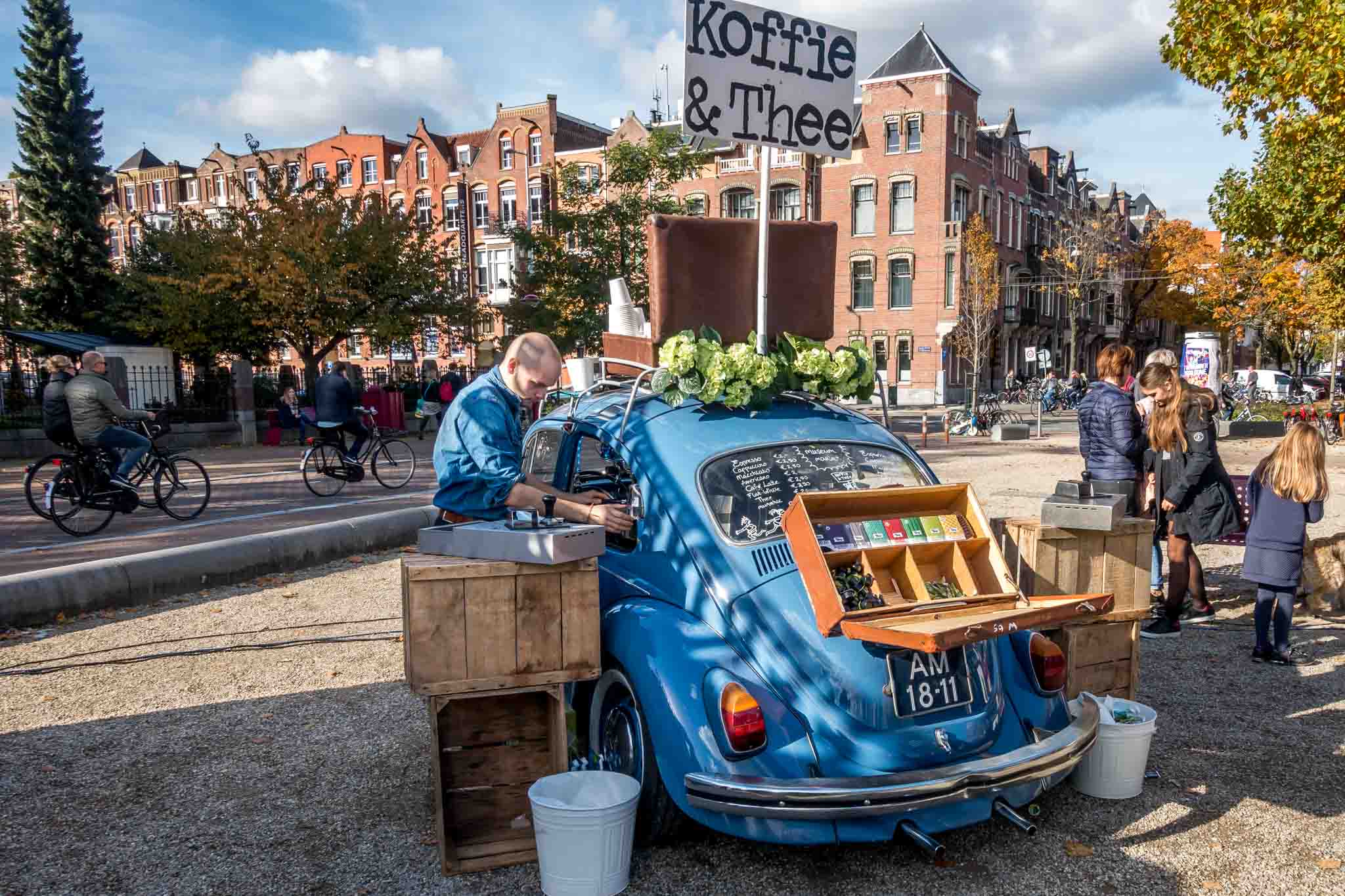 Man serving coffee from a VW bug at the Museum market in Amsterdam
