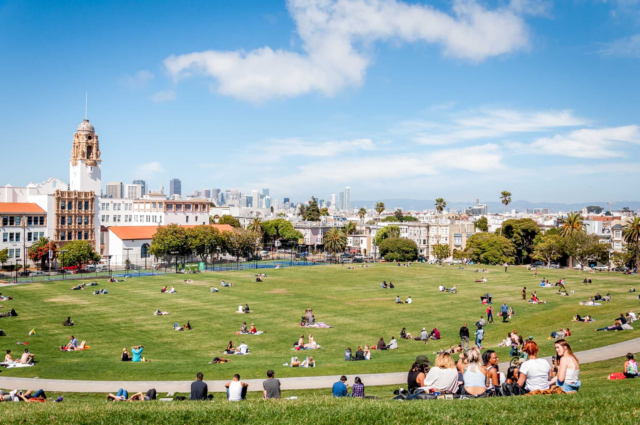 People in San Francisco's Mission Dolores Park overlooking the city