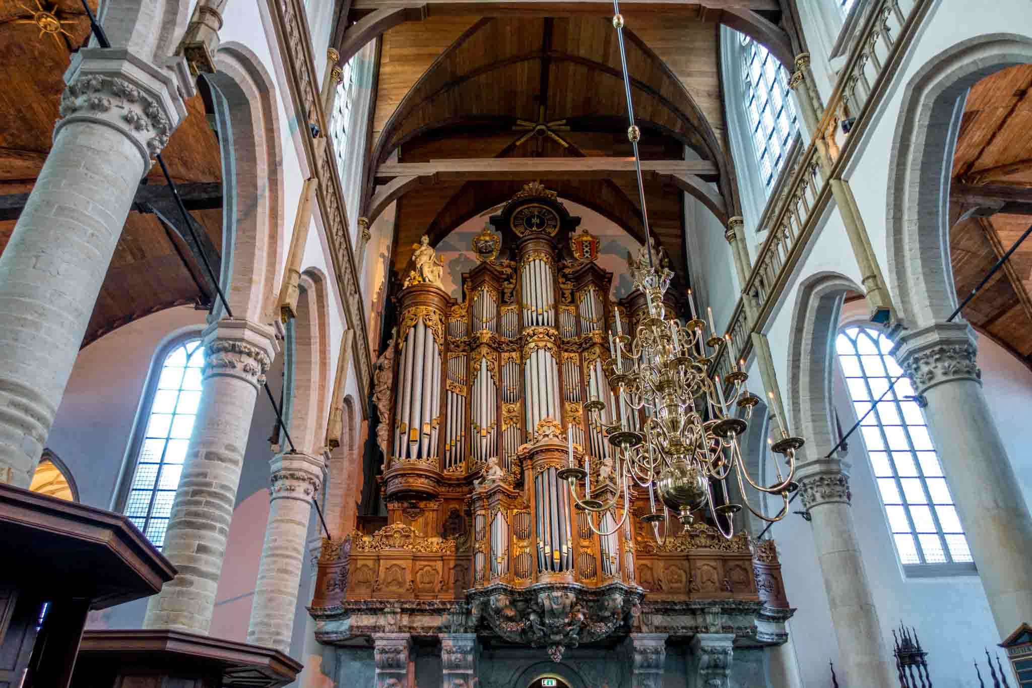 Large pipe organ decorated with statues and wood carvings