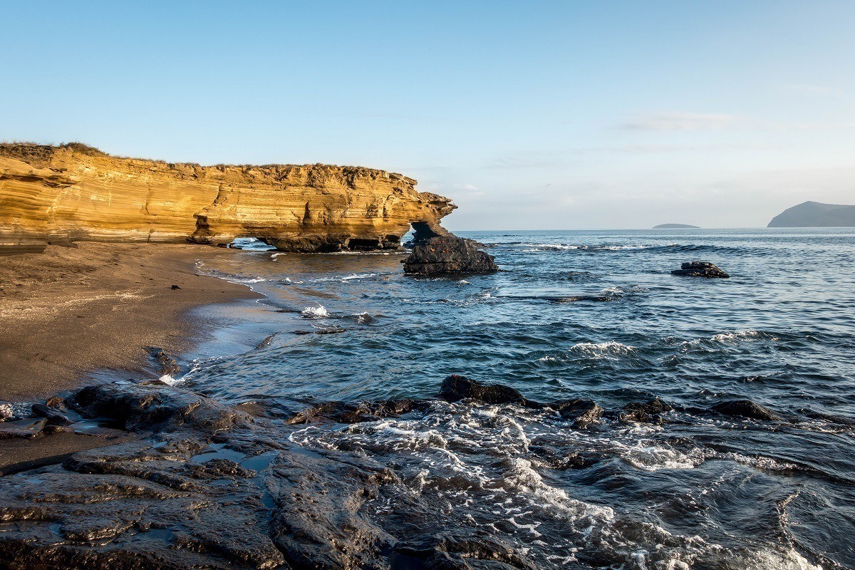 Rocks and black sand beach of Santiago Island