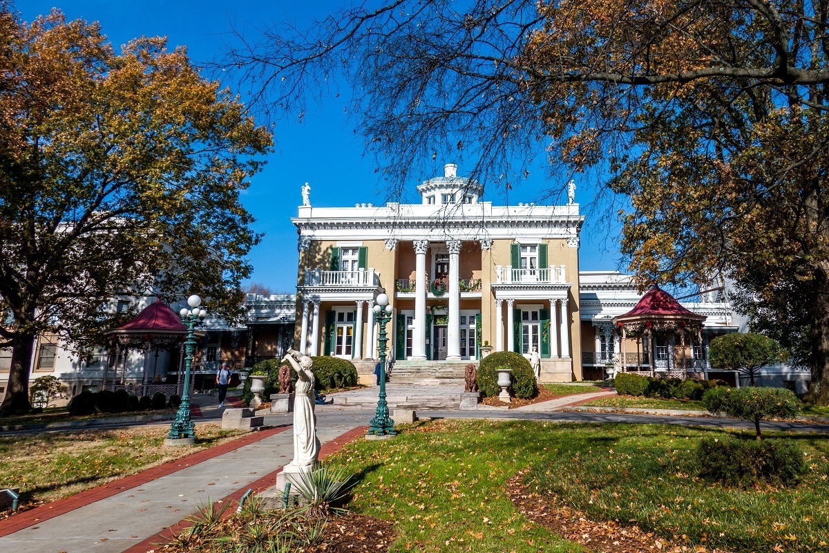 Exterior of a yellow and white mansion with columns known as Belmont Mansion in Nashville, Tennessee