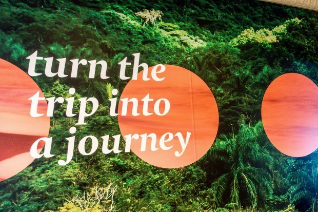 "turn the trip into a journey" -- a poster reminder on Fathom cruise line's Adonia ship
