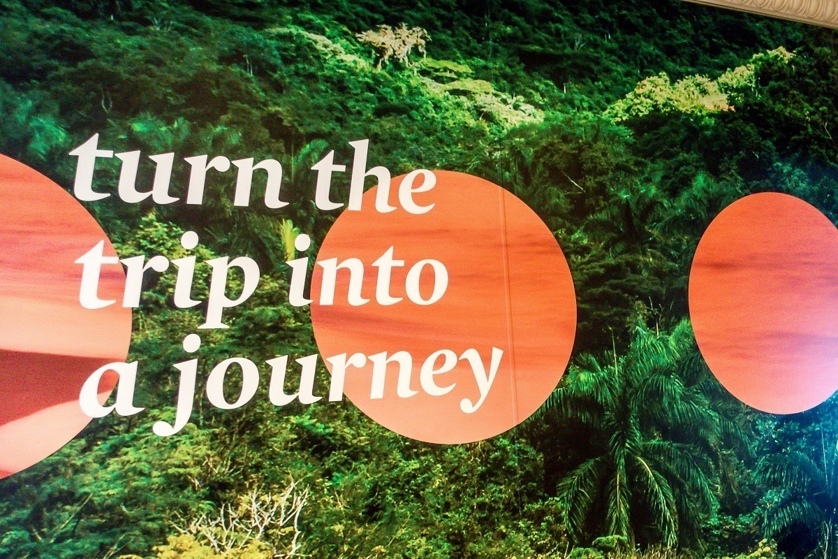 "turn the trip into a journey" -- a poster reminder on Fathom cruise line's Adonia cruise ship