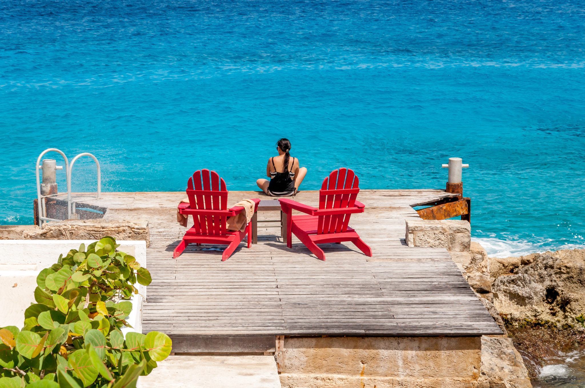 The red chairs on the small dock at the Hotel B Cozumel.