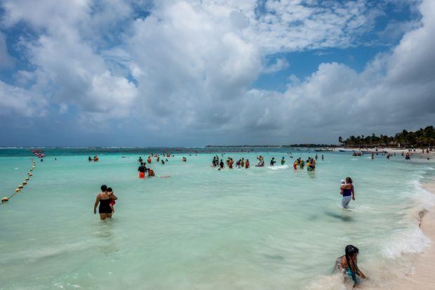 The buoyed section of Akumal beach with groups of snorkelers
