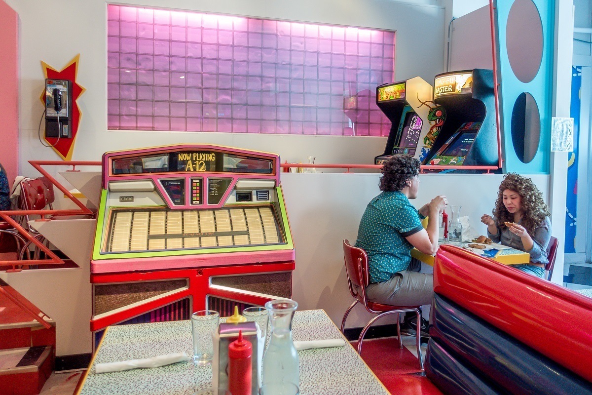 People eating in diner by a jukebox