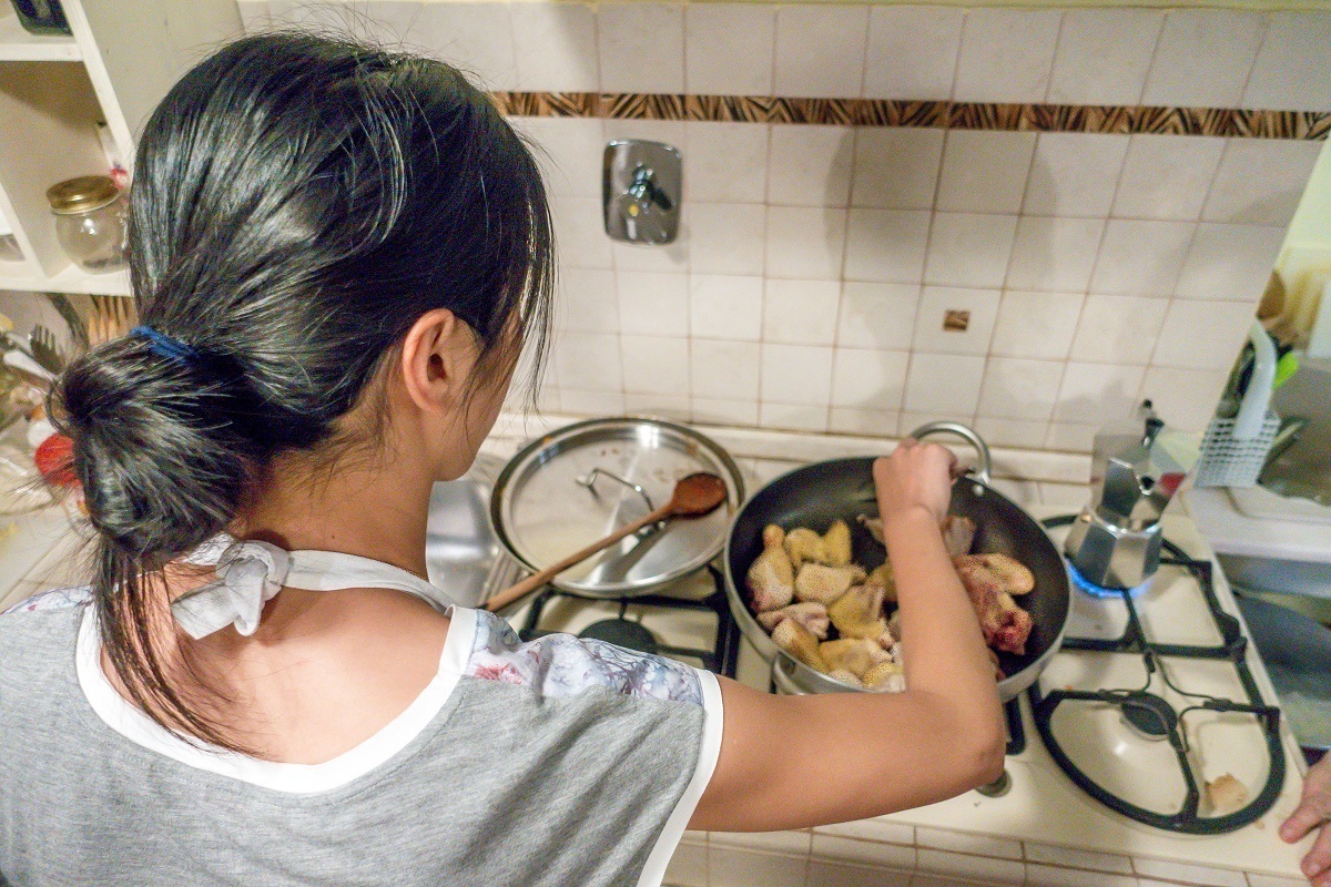 Cooking chicken during a cooking class in Rome, Italy