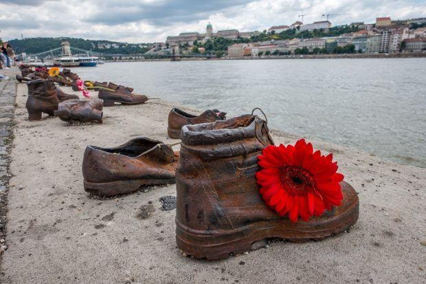 Visitors often leave flowers at Shoes on the Danube in tribute to the victims of the Holocaust
