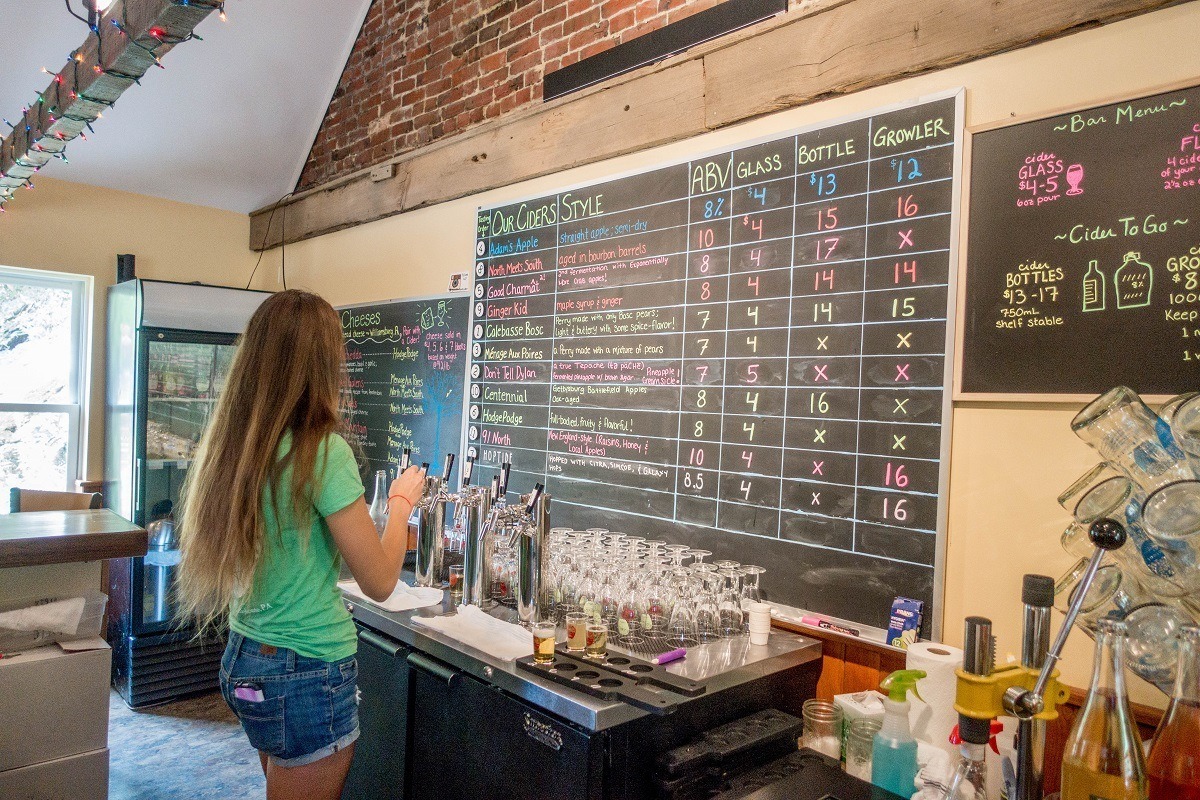 Woman pouring cider at Good Intent Cider