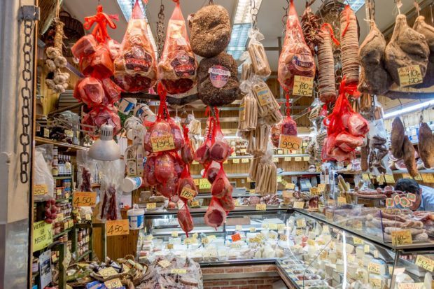 Lots of cured meat and cheese items are available at Mercato delle Erbe in Bologna, Italy