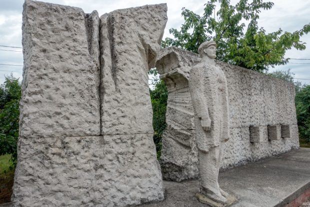 A worker -- quite literally -- breaking through a wall of oppression at Budapest's Memento Park