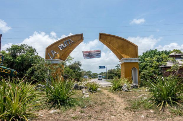 The dilapidated Ruta de los Cenotes sign in Puerto Morelos, Mexico.