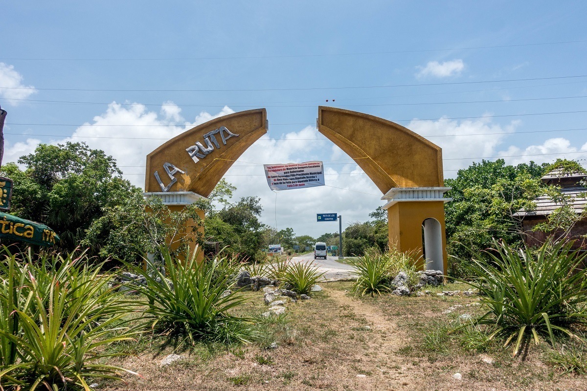 The dilapidated Ruta de los Cenotes sign in Puerto Morelos, Mexico.