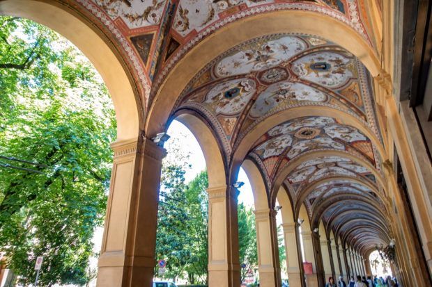 Strolling under the beautiful porticoes is one of the things to do when you visit Bologna, Italy