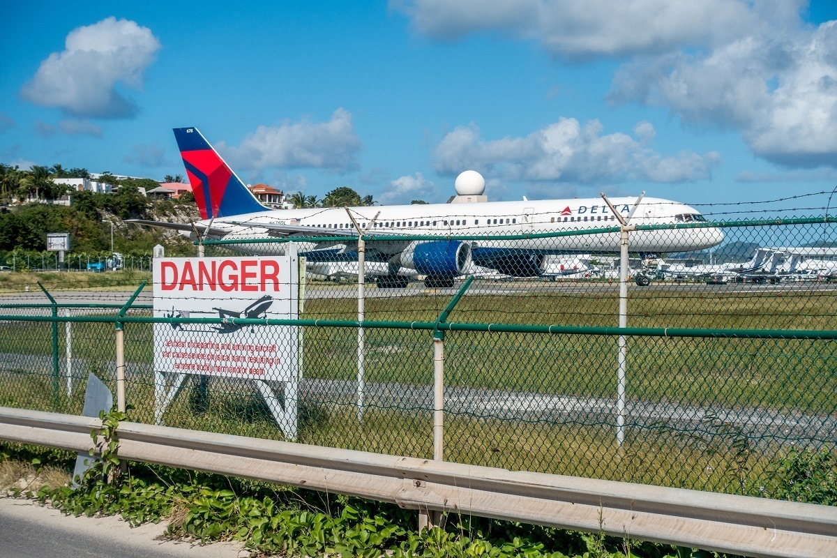 Plane behind a sign about the dangers of being too close