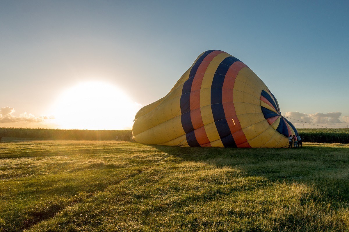 Inflating a hot air balloon at sunrise