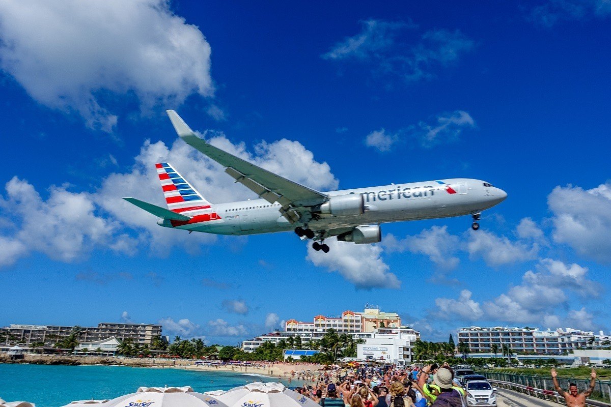 Jet landing over Maho Beach at Princess Juliana International Airport in Saint Martin.