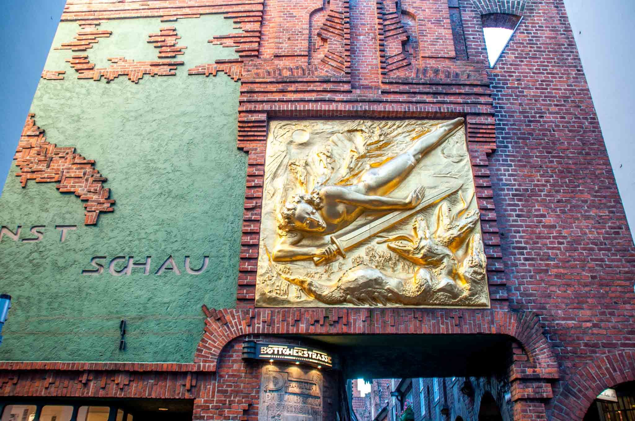 The gold entrance to Böttcherstrasse, the street of art, is what to see in Bremen Germany for lovers of art and architecture