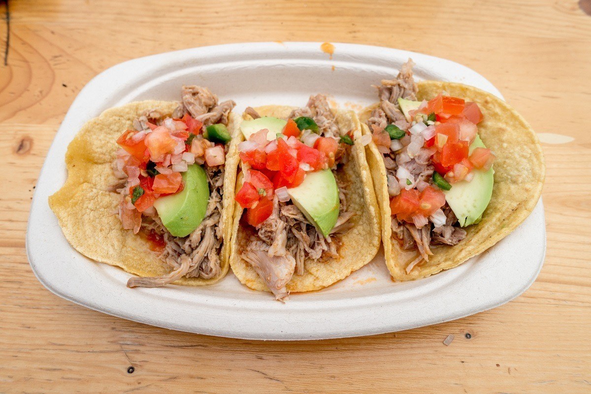 Carnitas tacos with avocado and salsa on a plate