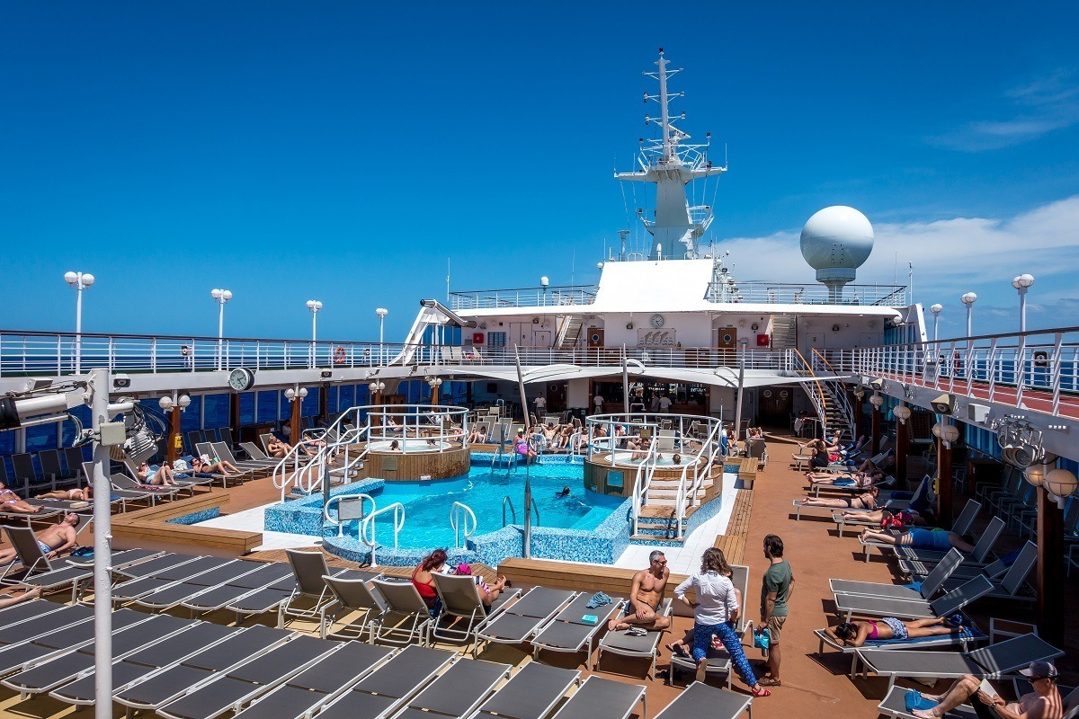Lounge chairs by the swimming pool on a cruise ship