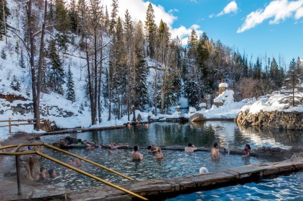Dipping into the Strawberry Park Hot Springs in Steamboat Springs, Colorado. This is the best natural hot springs in Colorado.