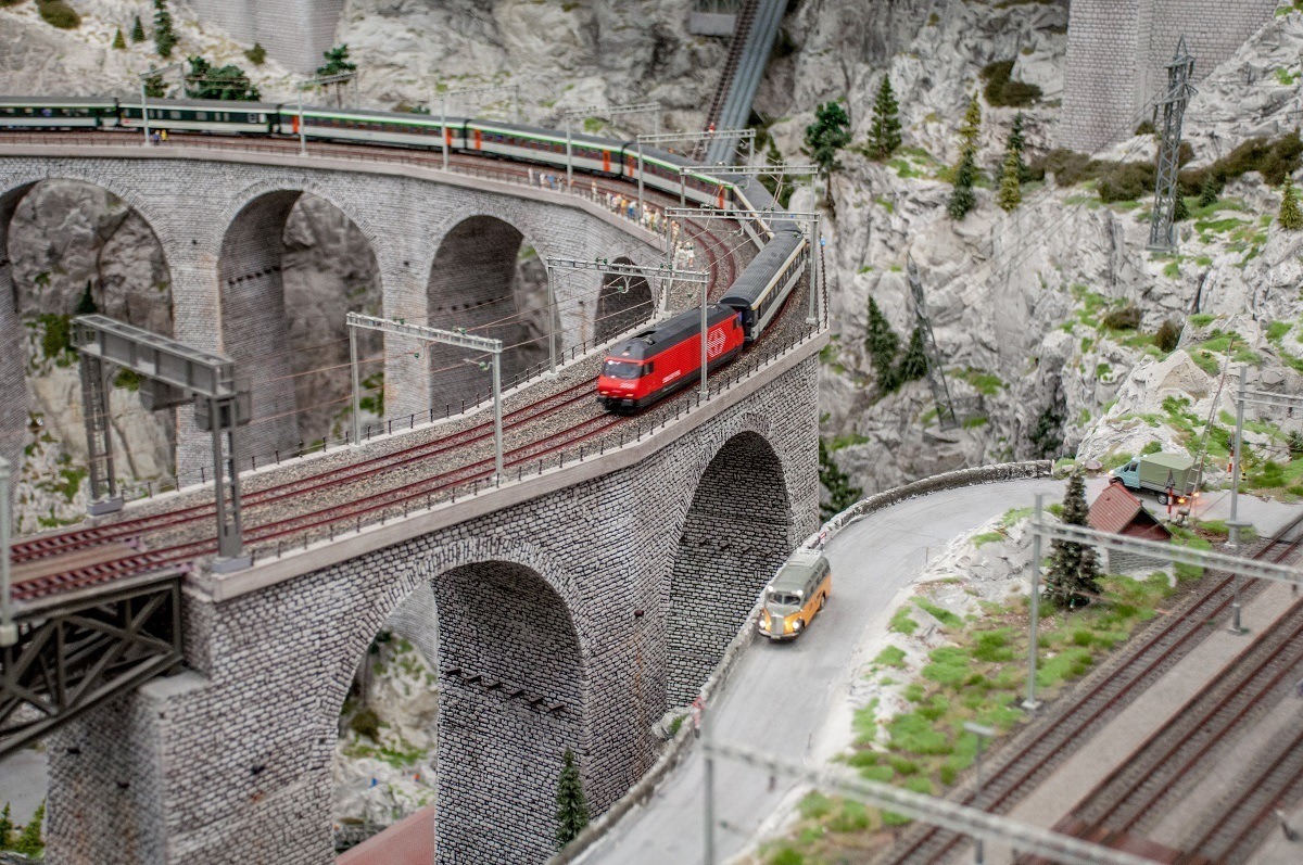 Model railroad train crossing bridge on the largest model train set in the world