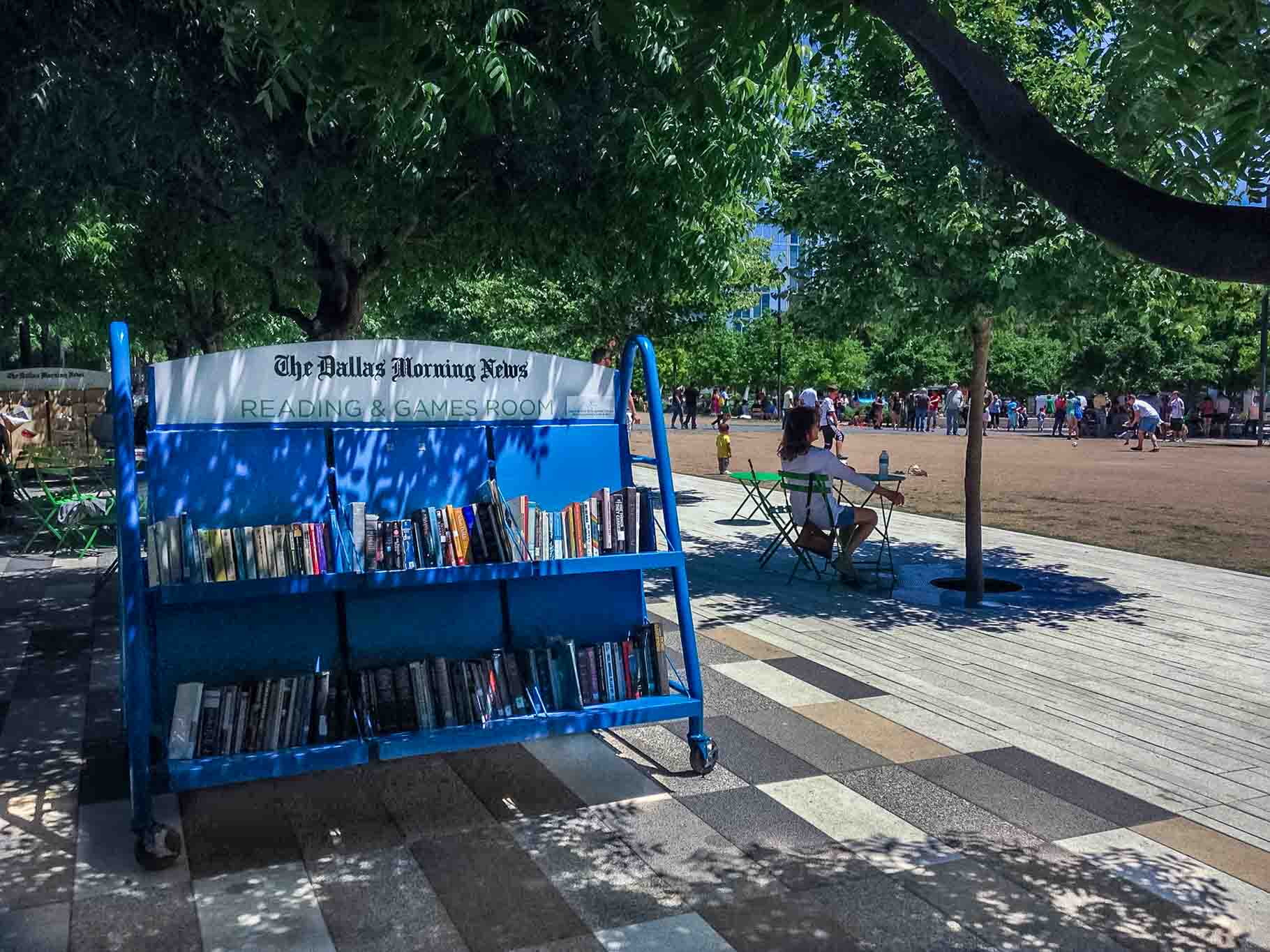 Reading area and books on shelf at Klyde Warren Park