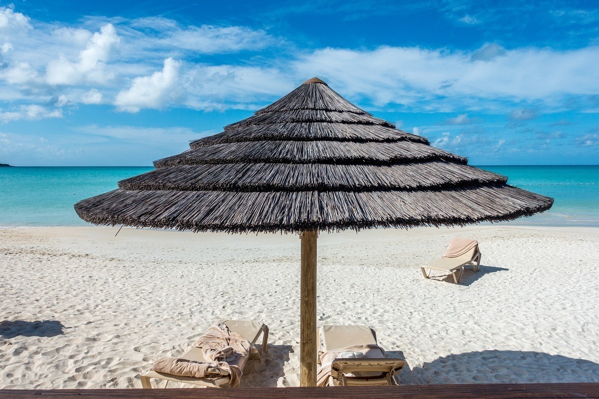 Sun shade and a couple of lounge chairs on one of the 365 beaches of Antigua