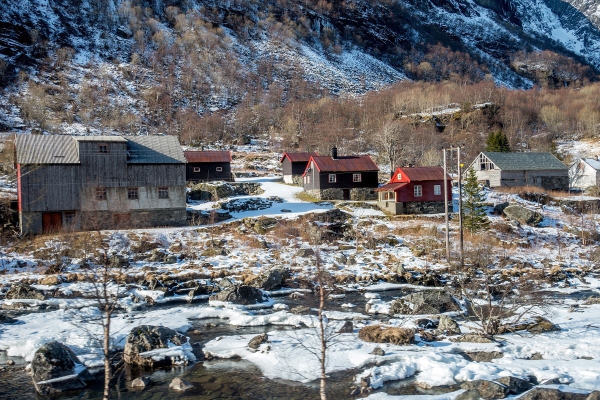 Red and green buildings in a snowy landscape in Norway