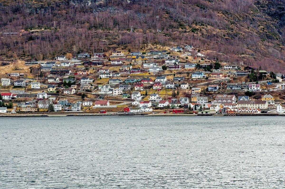 Colorful buildings on a hill overlooking the water in a fjord